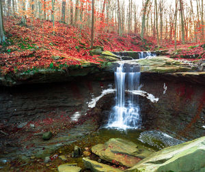 Scenic view of waterfall in stream