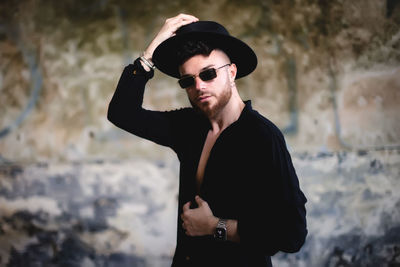 Young man wearing sunglasses while standing outdoors