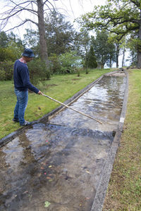 Side view of man standing on footpath