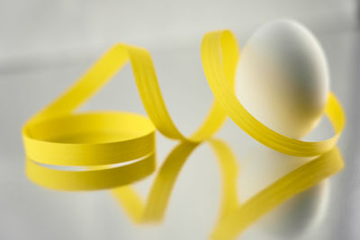 Close-up of yellow over white background