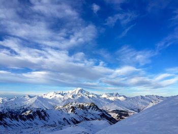Scenic view of snowcapped mountains against blue sky