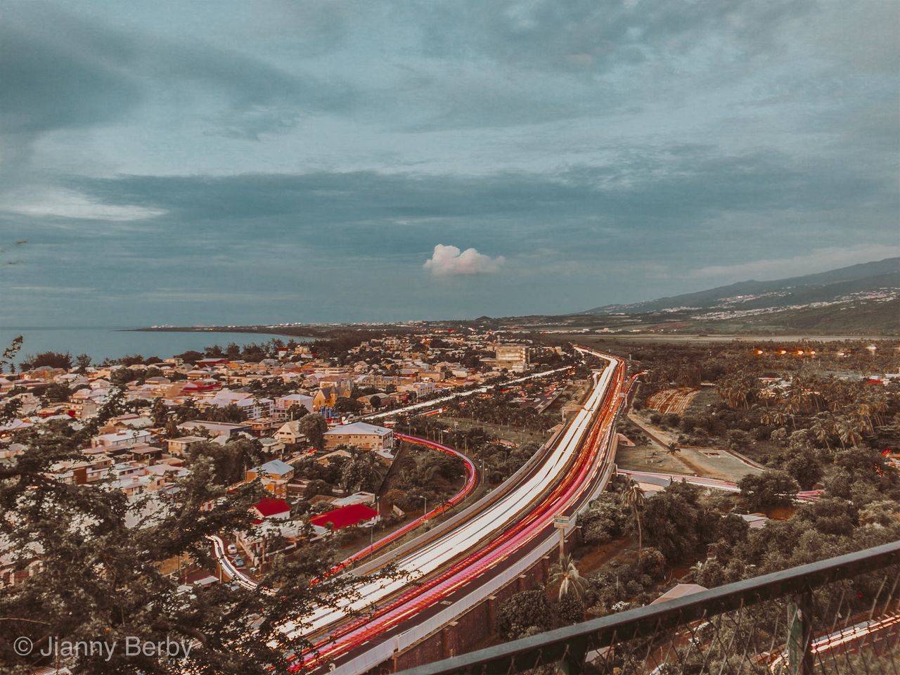 HIGH ANGLE VIEW OF ROAD AGAINST SKY IN CITY