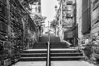 Low angle view of steps amidst buildings