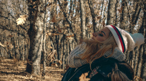 Woman wearing hat in forest