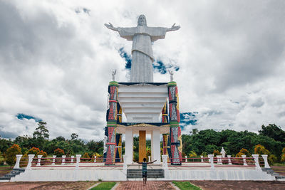 Statue of temple against cloudy sky