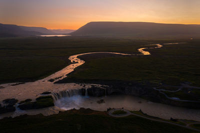 High angle view of land against sky during sunset