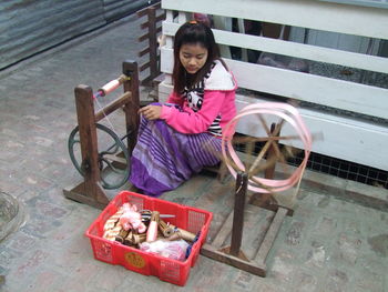 Portrait of woman with pink sitting outdoors