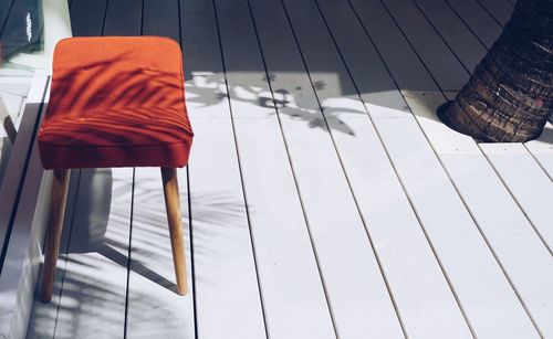 High angle view of empty stool on floorboard