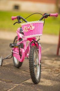 Close-up of toy bicycle on footpath