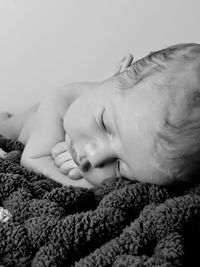 Close-up of cute girl sleeping on bed