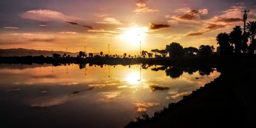 Scenic view of lake against sky during sunset