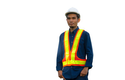 Portrait of young man standing against white background