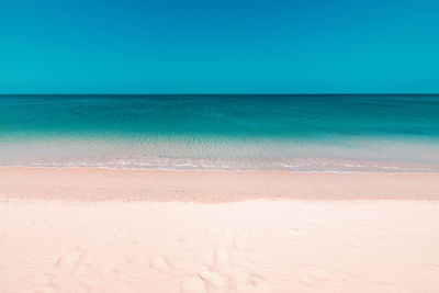 Scenic view of sea against clear blue sky