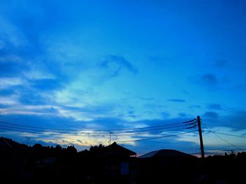 Low angle view of silhouette buildings against sky at dusk