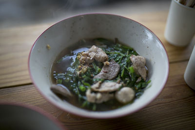 Close-up of soup in bowl on wooden table