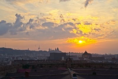 Buildings in city during sunset