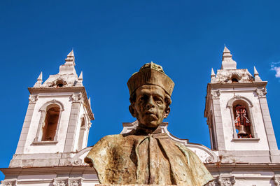 Low angle view of statue against blue sky