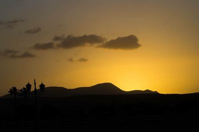 Silhouette landscape against sky during sunset