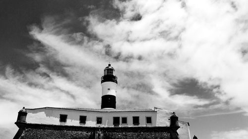 Low angle view of barra lighthouse against cloudy sky