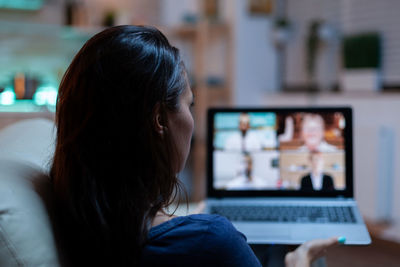 Young woman using laptop at home