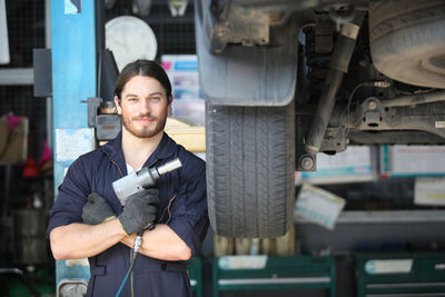 Portrait of young man working in car