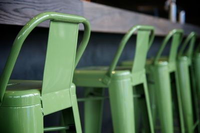 Green barstools arranged by counter