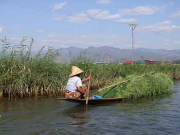 Man on boat against sky