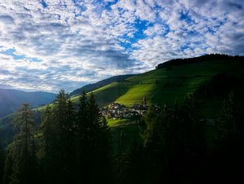 Scenic view of mountains against cloudy sky