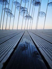 Bridge over sea against sky during sunset