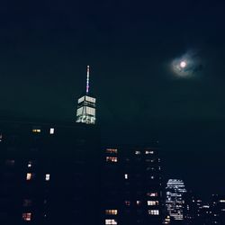 Low angle view of illuminated building against sky at night