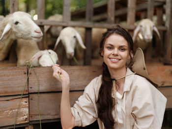 Portrait of young woman with goat