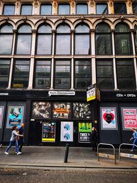 Man walking on street against building in city