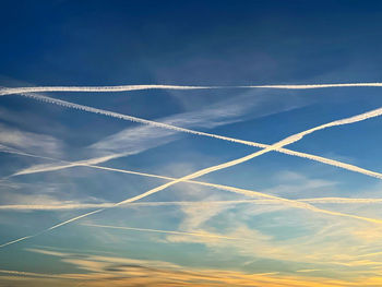 Low angle view of vapor trail