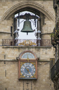 Low angle view of clock tower amidst buildings