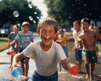 Portrait of boy playing with balloons