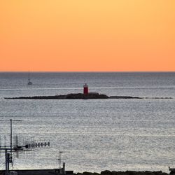 Scenic view of calm sea at sunset