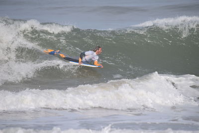 People surfing in sea