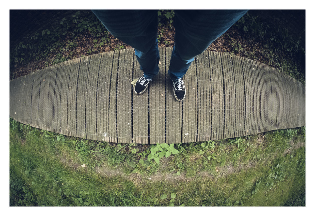 LOW SECTION OF PERSON STANDING ON LAND