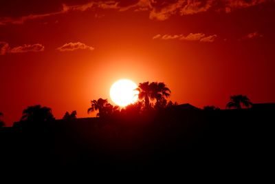 Scenic view of silhouette trees against romantic sky at sunset