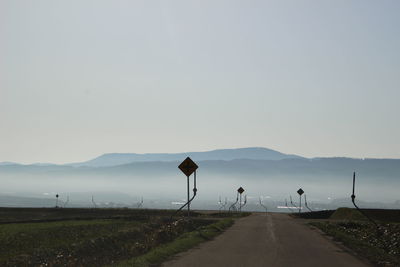 Road amidst mountains against sky