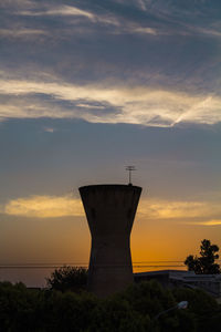 Silhouette plant against orange sky