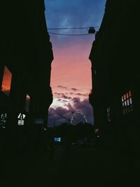 Silhouette city against sky at night