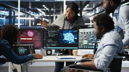 Rear view of people working at office