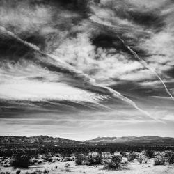 Scenic view of mountains against cloudy sky