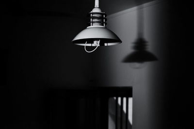 Close-up of electric lamp hanging at home