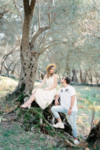 Full length of woman sitting on field