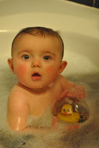 Portrait of baby boy in bathtub