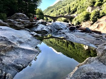 Scenic view of river and mountains against sky