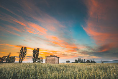 Scenic view of field against sky during sunset