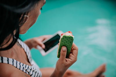 Midsection of woman using mobile phone